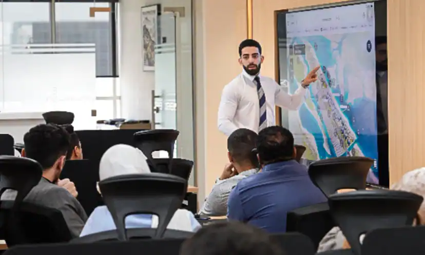 A training session on Abu Dhabi communities, with a map on screen