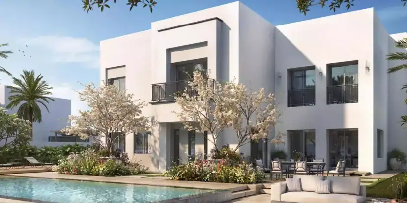 Rendering of a white two-story house with dark framed windows and a small balcony, with a swimming pool, flowering trees and an outdoor sofa in front.