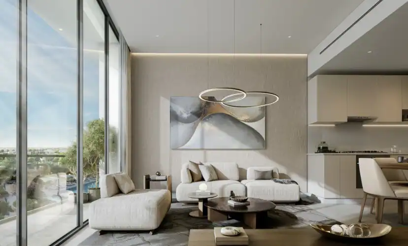 Rendering of a living room with a cream sectional sofa, round coffee tables, a ring-shaped pendant light, abstract wall art and floor-to-ceiling windows beside an open kitchen.