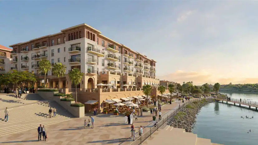 Rendering of a multi-story apartment building beside a waterfront promenade with cafe umbrellas, wide steps, pedestrians, palm trees, and a pier extending over the water.