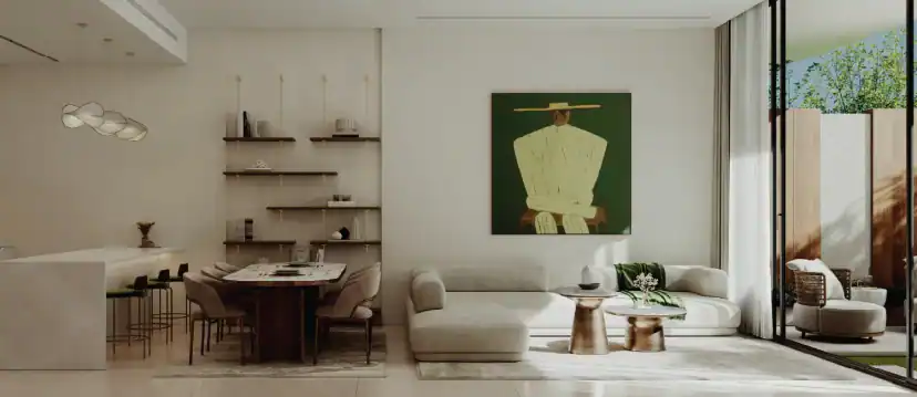 Open living and dining area with a pale sofa, round side tables, a dining table, wall shelves and a green painting, next to a glass door to a patio.