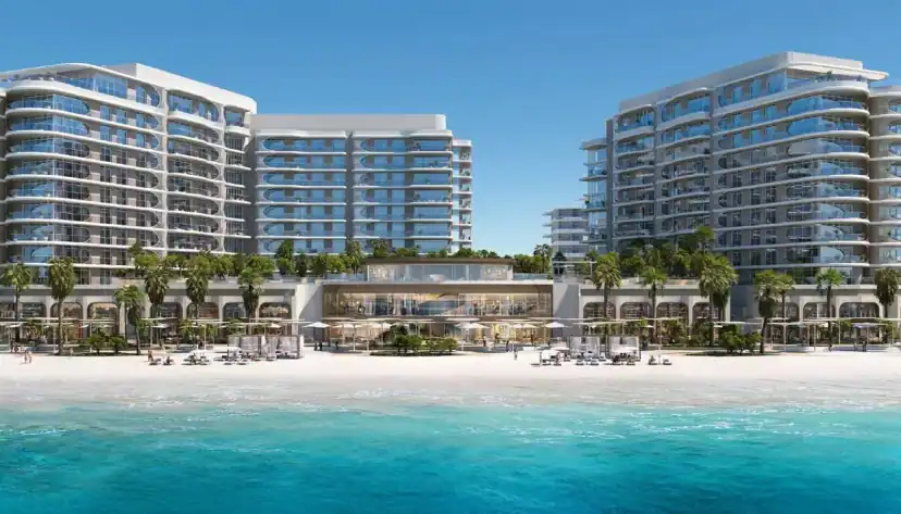 Beachfront apartment buildings beside turquoise water
