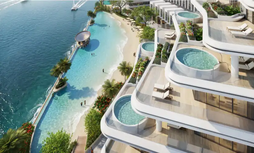 Aerial rendering of a curved white waterfront building with terraces, small round plunge pools and loungers, beside a lagoon-style pool with a sandy edge and palm trees.