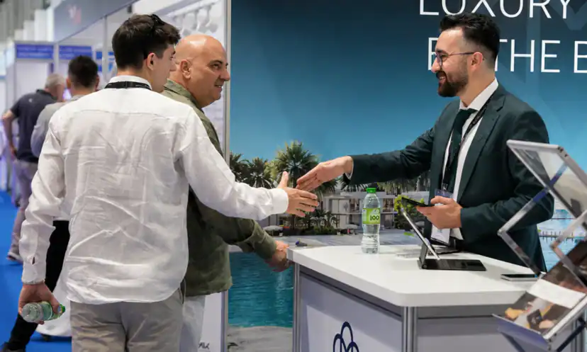 A Masterpiece Property advisor welcoming a buyer at a property show