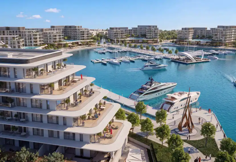 Rendering of a white terraced apartment building with balconies overlooking a marina with yachts, a boardwalk, a bronze sculpture and more buildings across the water.
