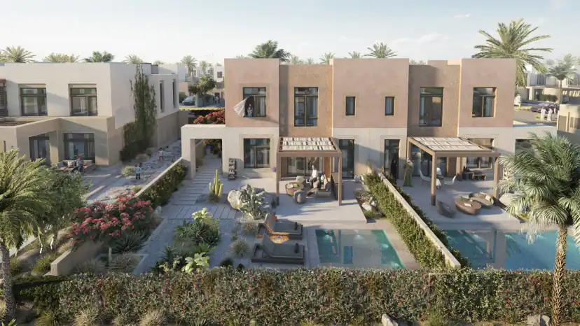 Rendering of the rear of attached two-story houses with pergola-covered patios, outdoor seating, two pools, a cactus garden and a flowering shrub in front of a hedge.