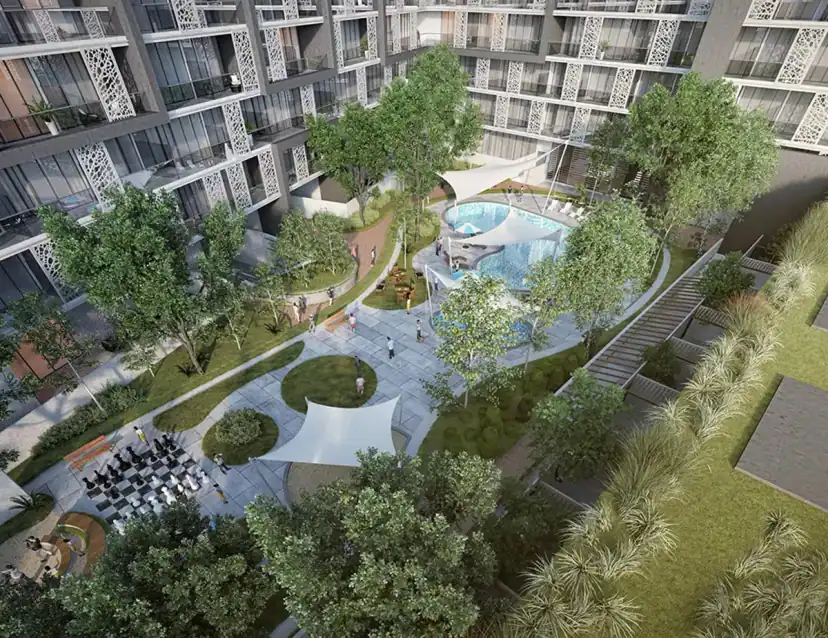 Aerial rendering of a landscaped courtyard between apartment towers, with a swimming pool, shade sails, walking paths, trees and a large outdoor chessboard.